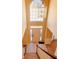 Grand two-story foyer with a high arched window and decorative lighting fixture at 2030 Calmwater Ct, Suwanee, GA 30024