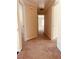 Hallway with neutral carpet, light walls, and doorways leading to various rooms at 2030 Calmwater Ct, Suwanee, GA 30024