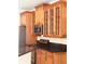 Kitchen features wood cabinets, stainless steel appliances, and granite countertops at 2030 Calmwater Ct, Suwanee, GA 30024