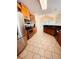 Bright kitchen featuring stainless steel appliances, dark countertops, and tile flooring at 2030 Calmwater Ct, Suwanee, GA 30024