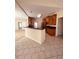 Open kitchen area with tile floors, breakfast bar, and wood cabinets at 2030 Calmwater Ct, Suwanee, GA 30024