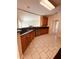 Traditional kitchen with wooden cabinets, black countertops, and tile flooring at 2030 Calmwater Ct, Suwanee, GA 30024