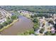 Breathtaking aerial perspective of a lakefront community nestled among lush trees and serene waters at 2030 Calmwater Ct, Suwanee, GA 30024