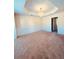 An airy living room with a decorative chandelier and ample space for entertaining at 2030 Calmwater Ct, Suwanee, GA 30024