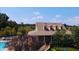 Clubhouse and outdoor pool area with a sun deck surrounded by lush landscaping for relaxing afternoons at 2030 Calmwater Ct, Suwanee, GA 30024