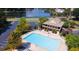 Aerial view of a community outdoor pool, clubhouse, and lakeside parking area at 2030 Calmwater Ct, Suwanee, GA 30024