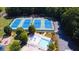 An aerial view showcases the community tennis courts, recreation area, and adjacent parking at 2030 Calmwater Ct, Suwanee, GA 30024