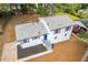 Aerial view of a beautiful home with a new roof, vibrant blue door, and beautifully landscaped yard at 6539 Hayes Dr, Riverdale, GA 30274