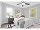 Well-lit bedroom featuring a ceiling fan, stylish decor, and a comfortable bed at 6539 Hayes Dr, Riverdale, GA 30274