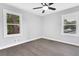 Spacious bedroom featuring hardwood floors, large windows, and ample natural light at 6539 Hayes Dr, Riverdale, GA 30274