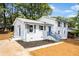 Beautiful white brick home with blue shutters, a freshly landscaped yard, and a cozy feel at 6539 Hayes Dr, Riverdale, GA 30274