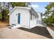 Charming white home with a blue front door and well-manicured landscaping at 6539 Hayes Dr, Riverdale, GA 30274