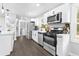 A bright, modern kitchen showcasing stainless steel appliances, white cabinets, and sleek countertops at 6539 Hayes Dr, Riverdale, GA 30274
