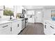 Bright kitchen featuring white cabinets, stainless steel appliances, and sleek countertops at 6539 Hayes Dr, Riverdale, GA 30274