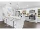 Modern kitchen with stainless steel appliances, white countertops and cabinets, and eat-in bar at 6539 Hayes Dr, Riverdale, GA 30274
