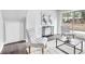 Bright living room features stylish chairs, modern table, and sliding glass doors to the backyard at 6539 Hayes Dr, Riverdale, GA 30274