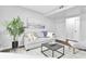 Cozy living room with a comfortable sofa, decorative pillows, and a large plant adding a touch of nature at 6539 Hayes Dr, Riverdale, GA 30274