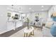 Open-concept living space with a sleek kitchen, dining area, and comfortable seating arrangement at 6539 Hayes Dr, Riverdale, GA 30274