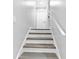 The wood and white staircase leading to the upper level of the home at 6539 Hayes Dr, Riverdale, GA 30274