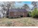 A view of the brick home's backyard reveals an exterior with ample space and potential for landscaping or recreation at 1579 Mayflower Sw Ave, Atlanta, GA 30311