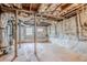 Unfinished basement with painted stone walls and exposed ceiling beams at 1579 Mayflower Sw Ave, Atlanta, GA 30311