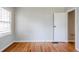 Bedroom with hardwood floors, neutral paint, natural light from window and closet at 1579 Mayflower Sw Ave, Atlanta, GA 30311