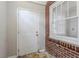 Exterior door with brick surround and window with blind at 1579 Mayflower Sw Ave, Atlanta, GA 30311