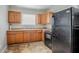Functional kitchen with black appliances, wood cabinets, and a bright window at 1579 Mayflower Sw Ave, Atlanta, GA 30311