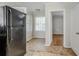 Well-lit eat-in kitchen with a refrigerator and view to another room at 1579 Mayflower Sw Ave, Atlanta, GA 30311