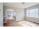 Cozy living room with hardwood floors, arched doorway, and natural light from windows at 1579 Mayflower Sw Ave, Atlanta, GA 30311