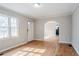 Cozy living room featuring hardwood floors and natural light from the large window at 1579 Mayflower Sw Ave, Atlanta, GA 30311