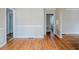 Open living space with hardwood floors and view to bathroom and second living area at 1579 Mayflower Sw Ave, Atlanta, GA 30311