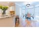 Bright dining area featuring hardwood floors, a chandelier, and large windows at 2660 Portabella Ln, Cumming, GA 30041