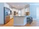 Spacious kitchen island with bar seating, stainless steel appliances, and granite countertops at 2660 Portabella Ln, Cumming, GA 30041
