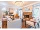 Comfortable living room featuring a stone fireplace, chandelier, and plenty of natural light at 2660 Portabella Ln, Cumming, GA 30041