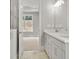 Bathroom featuring double sink vanity, modern fixtures, and a view to the bedroom and window at 408 Vinca Nw Cir, Kennesaw, GA 30144