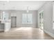 Open-concept living room with hardwood floors, lots of natural light, and access to a kitchen area at 408 Vinca Nw Cir, Kennesaw, GA 30144