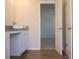 Bathroom with granite countertops, vinyl floors, and an open view to another room with a carpeted floor at 651 Egrets Landing #53, Covington, GA 30014