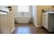 The bathroom features a modern freestanding bathtub and a window for natural light, enhancing relaxation at 651 Egrets Landing #53, Covington, GA 30014