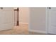 A carpeted hallway features a wooden railing with iron spindles and a partial view of two doors at 651 Egrets Landing #53, Covington, GA 30014