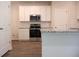 Bright kitchen area showcasing stainless steel oven and microwave with granite counters at 651 Egrets Landing #53, Covington, GA 30014