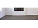 Open living room area with electric fireplace and durable wood-look floors at 651 Egrets Landing #53, Covington, GA 30014
