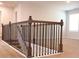A staircase with wood and iron railing ascends to the second floor, featuring neutral carpet and natural light at 651 Egrets Landing #53, Covington, GA 30014