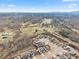 Spacious aerial view of the homes in a neighborhood surrounded by fields and mountains at 7995 Brewton Creek Dr, Cumming, GA 30028
