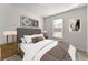 Bedroom with a large bed with a grey headboard and contemporary artwork at 7995 Brewton Creek Dr, Cumming, GA 30028