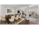 An open concept dining area that features a long table, fireplace, and open concept living space at 7995 Brewton Creek Dr, Cumming, GA 30028