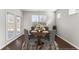 Dining room with wood floors, large windows and an elegant dining table with seating for four at 7995 Brewton Creek Dr, Cumming, GA 30028
