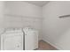 A laundry room with white appliances and tile flooring at 7995 Brewton Creek Dr, Cumming, GA 30028