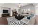 Comfortable living room with a stone fireplace, neutral tones, and stylish decor at 7995 Brewton Creek Dr, Cumming, GA 30028