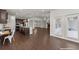 Bright and airy open-concept living space with hardwood floors, a kitchen, and a cozy fireplace at 7995 Brewton Creek Dr, Cumming, GA 30028